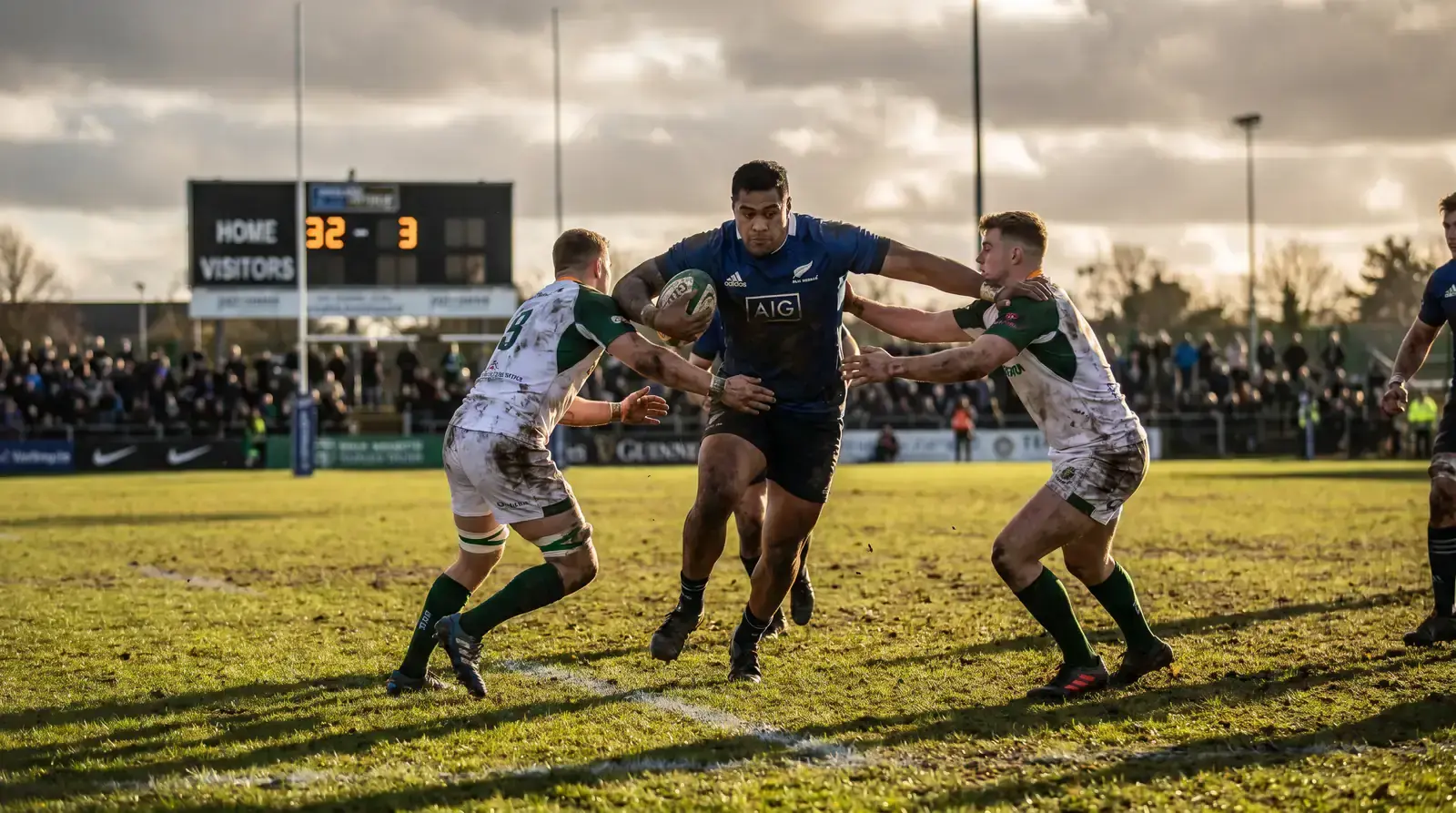 Rugby union favourite breaking through a tackle, illustrating an Asian handicap mismatch