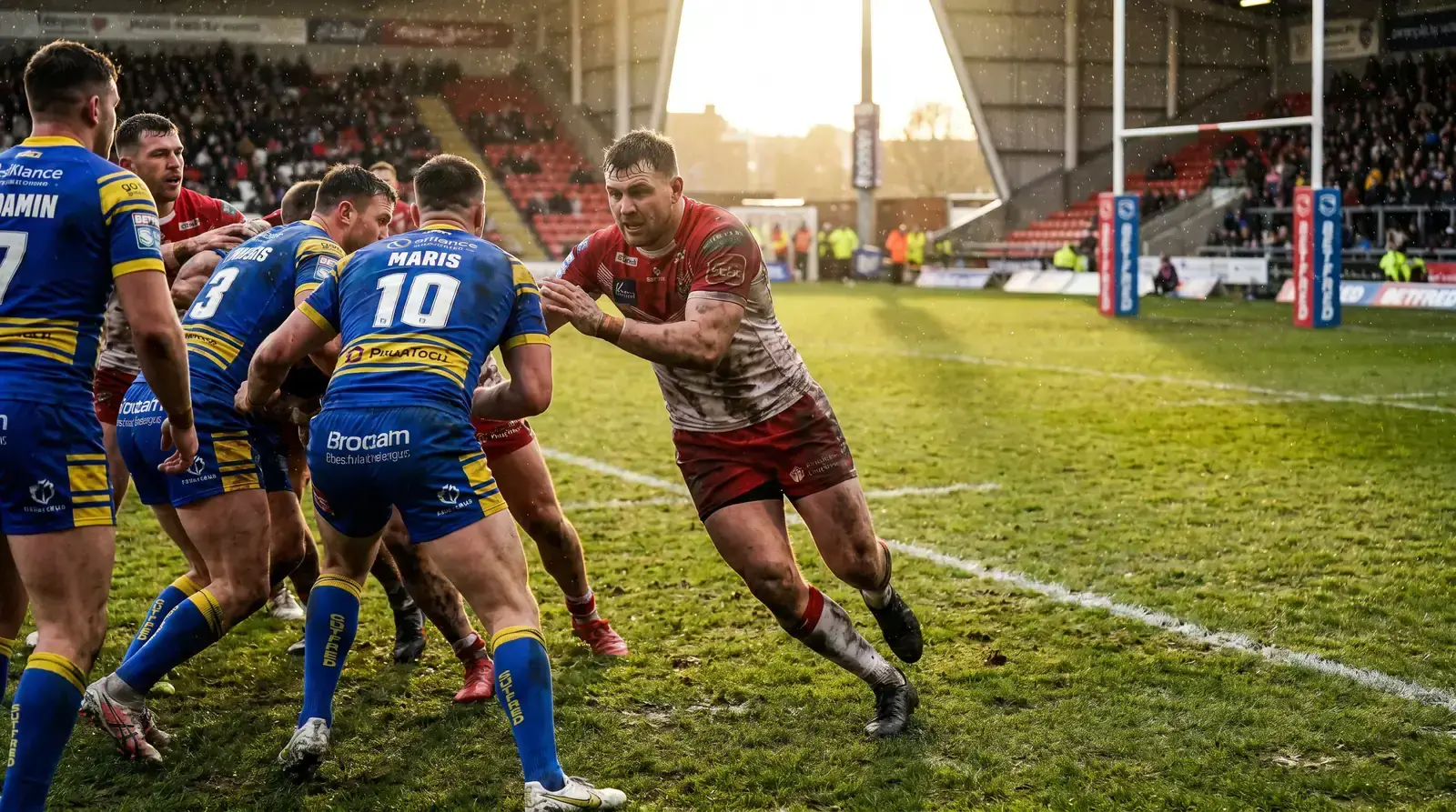 Super League rugby league match with a forward charging into the defensive line